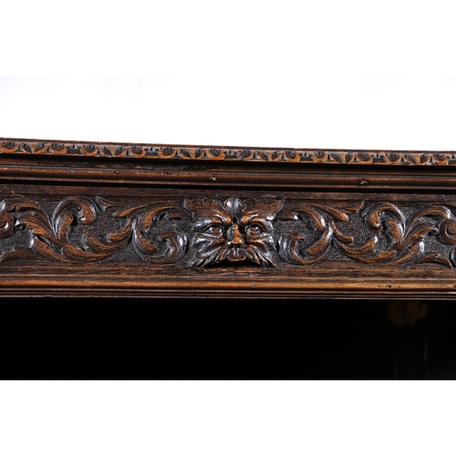 441 - Antique heavily carved oak break front bookcase, frieze fitted with three drawers above carved lion ... 