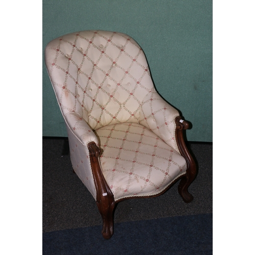 447 - Victorian mahogany cream upholstered armchair raised on cabriole supports.