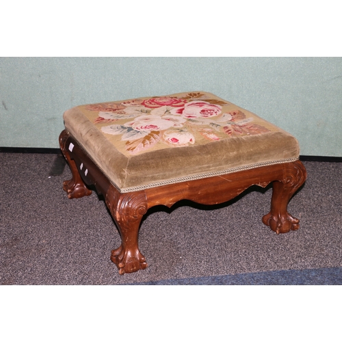 448 - Victorian mahogany upholstered footstool, the square floral top raised on ball and claw supports.