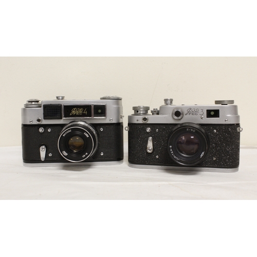 376 - Four vintage Russian film cameras to include Zorki 4K with a Helios Jupiter 50mm F2 lens and a Fed 3... 