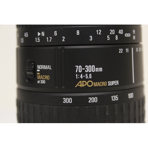 385 - Canon 50E SLR film camera with modern Sigma 70-300mm F4-5.6 APO macro super and Canon flash gun, in ... 