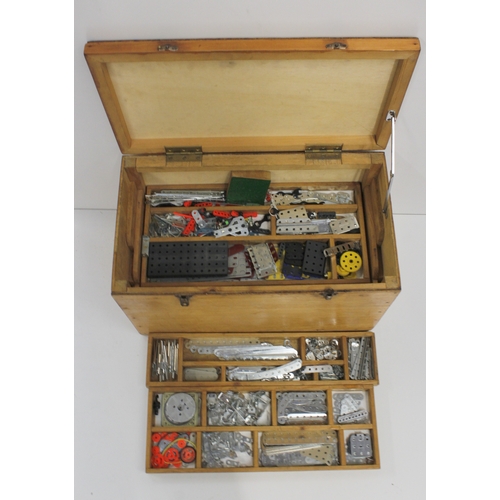 304 - Wooden chest containing Meccano parts in lift out segmented trays, the chest 46cm long