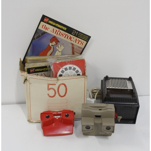 317 - 5 GAF handheld viewmaster slide viewers, also slides including Tarzan, Pinocchio, Alice and Wonderla... 