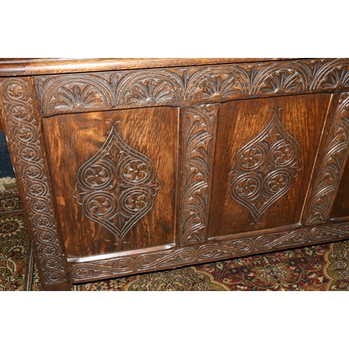 454 - Antique oak hinge top blanket box chest with carved fielded triple panel front raised on straight su... 