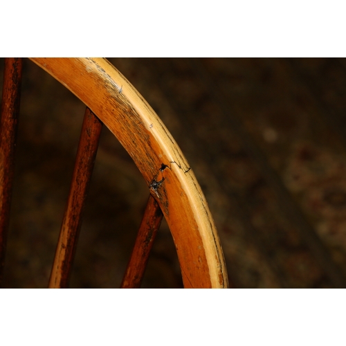 458 - Antique elm Windsor style arm chair with spindle back above saddled seat raised on turned supports