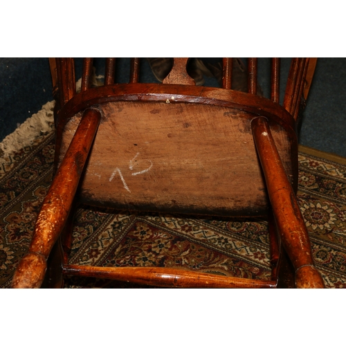 459 - Antique elm Windsor style arm chair with spindle and splat back rest, saddled seat and raised on tur... 