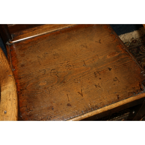 460 - Antique elm ash oak bar back arm chair with recurved arm rests, panel seat, raised on square taperin... 