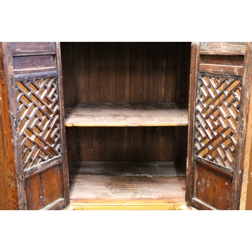 469 - Antique Chinese soft wood chicken coup cabinet of typical form with pierced doors raised on square s... 