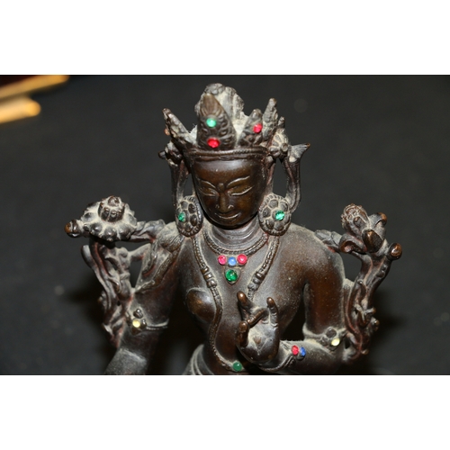 345 - A 19th century Indian bronze Tara seated on a double lotus throne, with inset glass 'jewels', carved... 