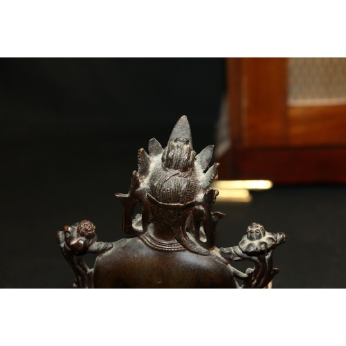 345 - A 19th century Indian bronze Tara seated on a double lotus throne, with inset glass 'jewels', carved... 