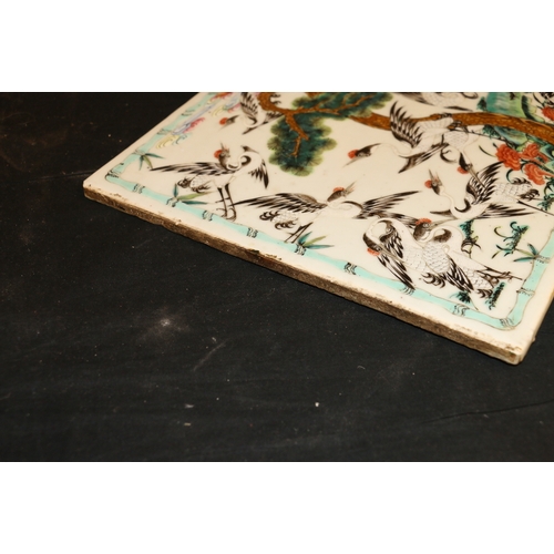 387 - Late 19th Century Chinese famille rose tile decorated with multiple cranes surrounding an old pine t... 