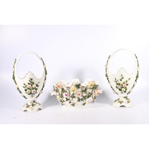 131 - Meissen style floral encrusted twin-handled basket and a pair of similar vases.