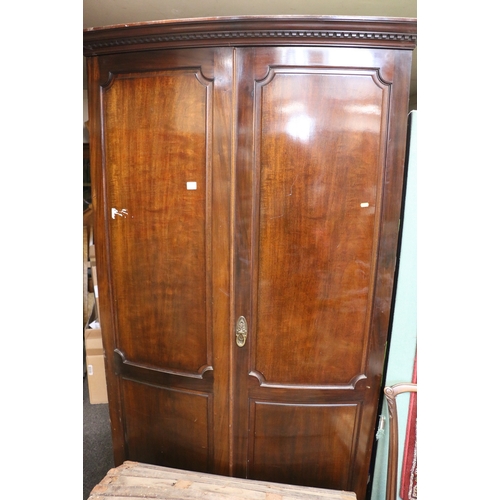 550 - Victorian mahogany two door wardrobe, with dentil work cornice, raised on bracket supports.