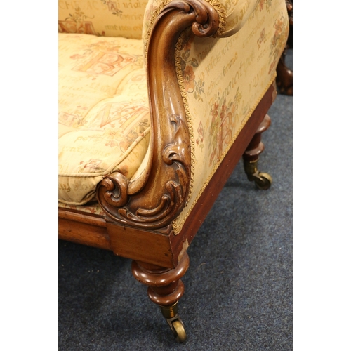 482 - Victorian mahogany framed sofa, with carved recurved arms raised on turned supports capped by brass ... 