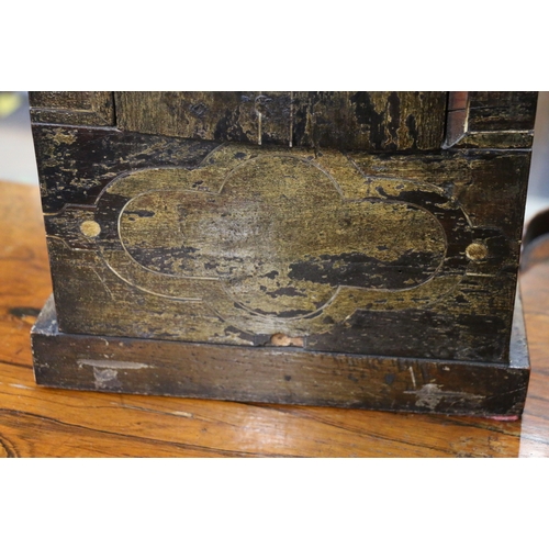 304 - An unusual carved mahogany death clock, the brass dial with gravestone supported by eagle, skull and... 