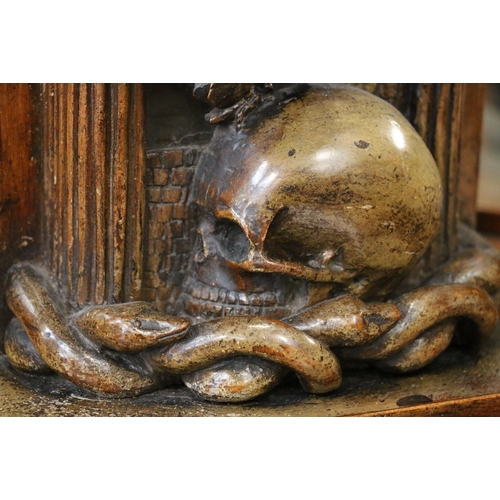 304 - An unusual carved mahogany death clock, the brass dial with gravestone supported by eagle, skull and... 