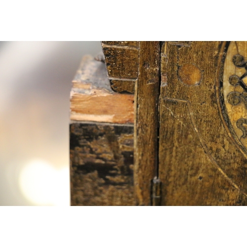 304 - An unusual carved mahogany death clock, the brass dial with gravestone supported by eagle, skull and... 