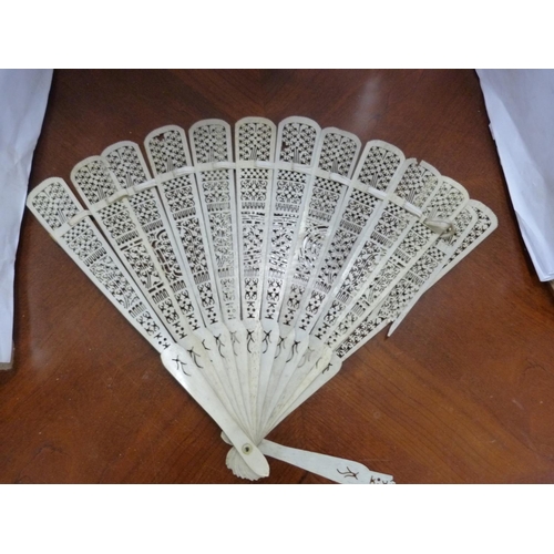 104 - Bone fan, oriental carved figures, travel iron and a parasol.