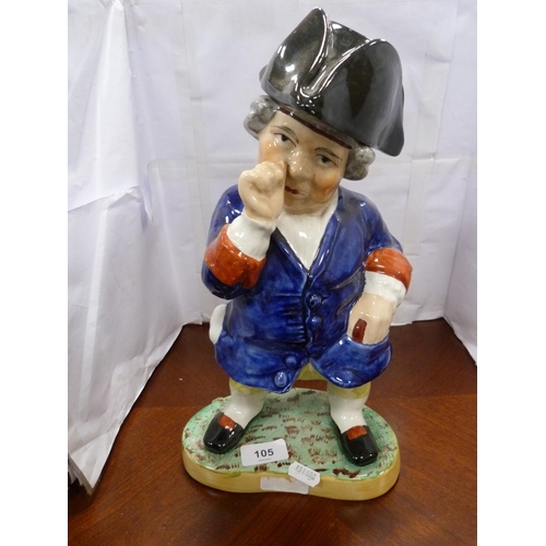 105 - Staffordshire style figure of a gentleman taking snuff.