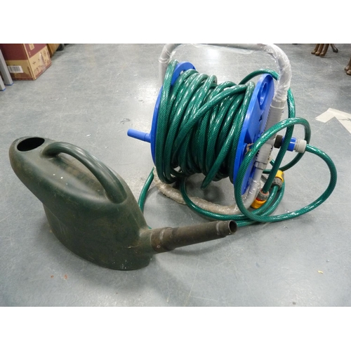 127 - Watering can and garden hose pipe.