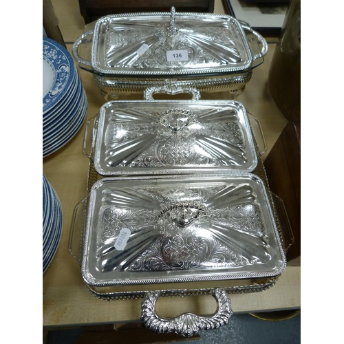 136 - Set of plated serving dishes.