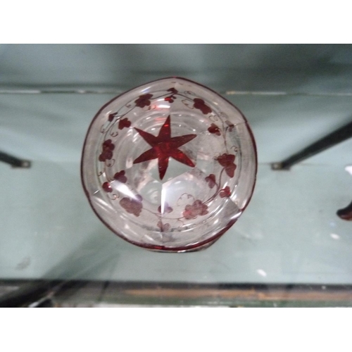 214 - Octagonal glass jar and cover with all over cranberry and vine leaf decoration.