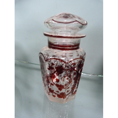 214 - Octagonal glass jar and cover with all over cranberry and vine leaf decoration.