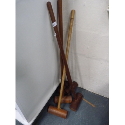 216 - Five croquet mallets.