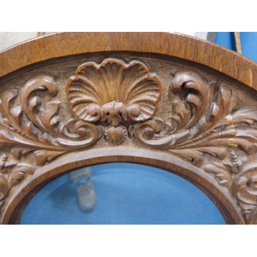 224 - Acanthus carved oval wall mirror.