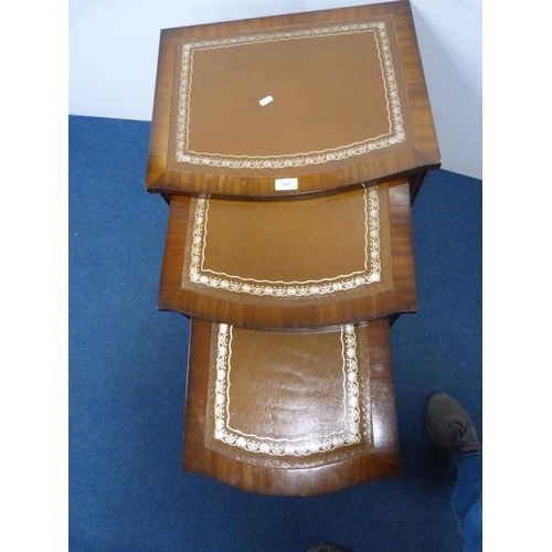 309 - Nest of three mahogany tables with brown inset top.