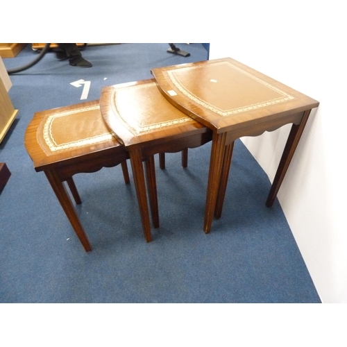 309 - Nest of three mahogany tables with brown inset top.