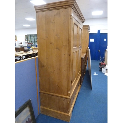 320 - Pine two-door wardrobe with drawers to the base.