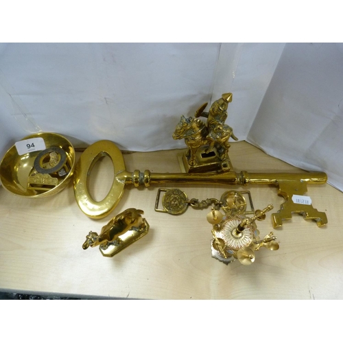 94 - Assorted brassware including Buddha, kettle, oversized key, Irish Guards belt buckle etc.