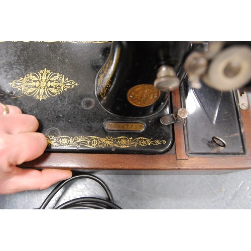 154 - Singer sewing machine.