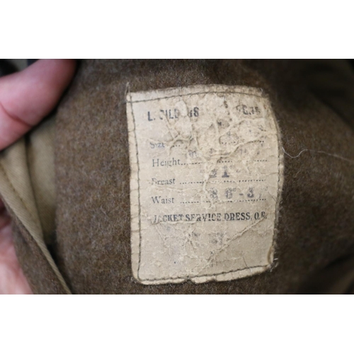 1138 - British Army uniform, a British Army khaki green battledress jacket with worn label having brass GRV... 