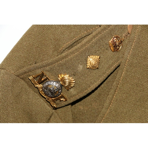 1149 - British Army uniform, a British Army khaki green jacket having two NF (Northumberland Fusiliers) epa... 