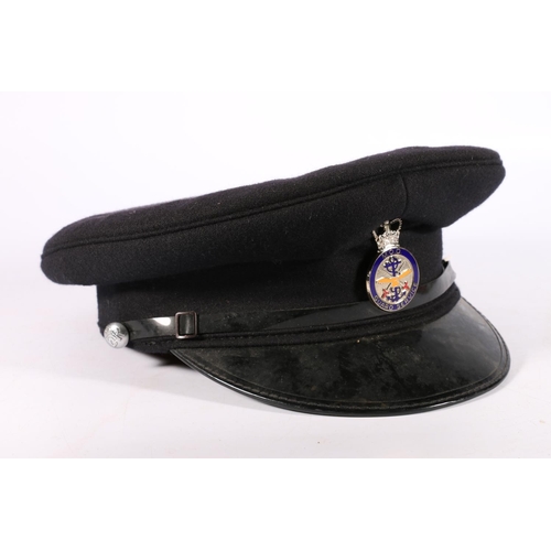 1162 - British Ministry of Defence uniform, an MOD peaked cap with black top and enamelled white metal Guar... 