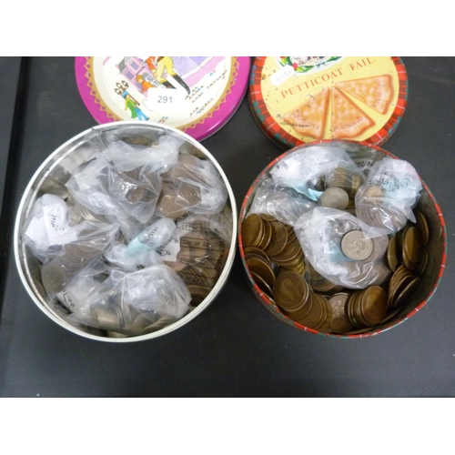 291 - Two tins of world coins including British pennies and 3d.