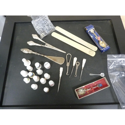 296 - Silver handled shoe horn, collectors' spoons, mixed coins and porcelain thimbles.