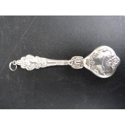 298 - Silver baby rattle with floral repousse decoration.