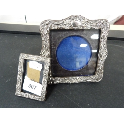 307 - Two silver picture frames with repousse scrollwork borders.  (2)