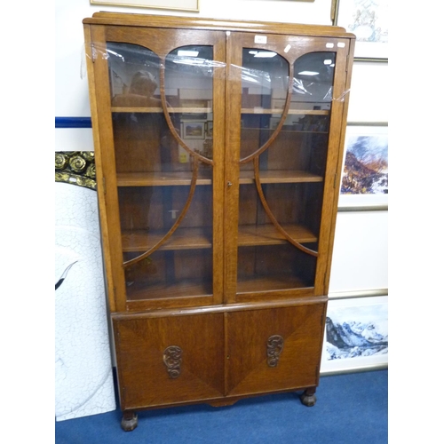 445 - Oak glazed bookcase with cupboards below.