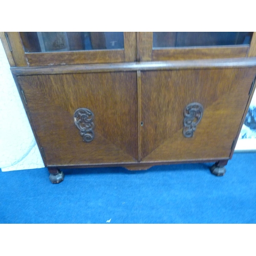 445 - Oak glazed bookcase with cupboards below.