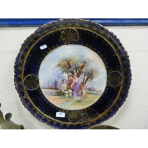 56 - Large wall-mounted collector's plate with blue and gilt border, the centre depicting a woman playing... 