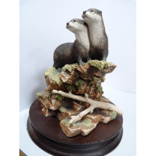 63 - Three Border Fine Arts models, 'Scenting the Air', 'The Terrier', and two otters.