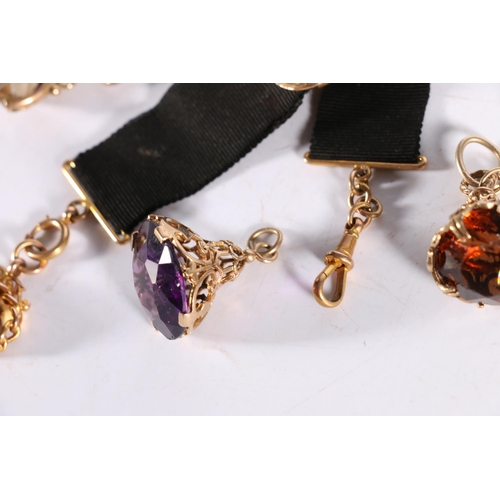 128 - Four 9ct gold mounted faceted citrine and amethyst fobs, 29.7g gross