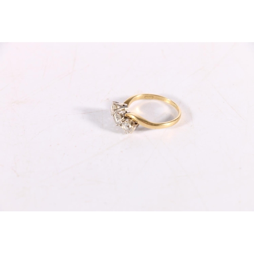 140 - 18ct yellow gold diamond three stone ring, the three diamonds arranged in a crossover setting, each ... 