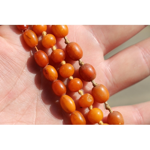 150B - Three strands of amber style beads, 66g gross