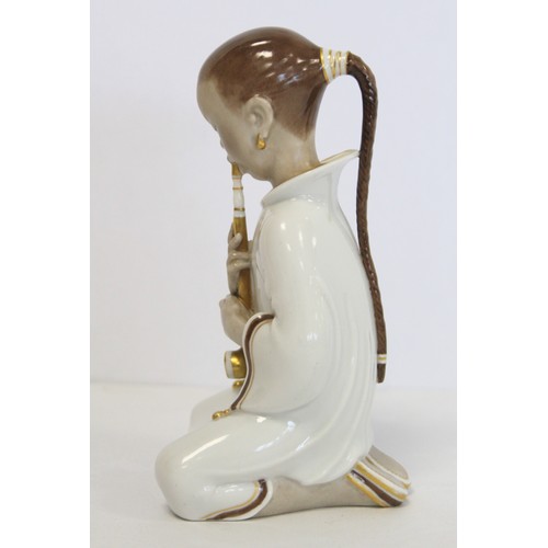 241 - Danish Royal Copenhagen porcelain figure of an opium smoker or girl smoking a pipe, no. 2342, design... 