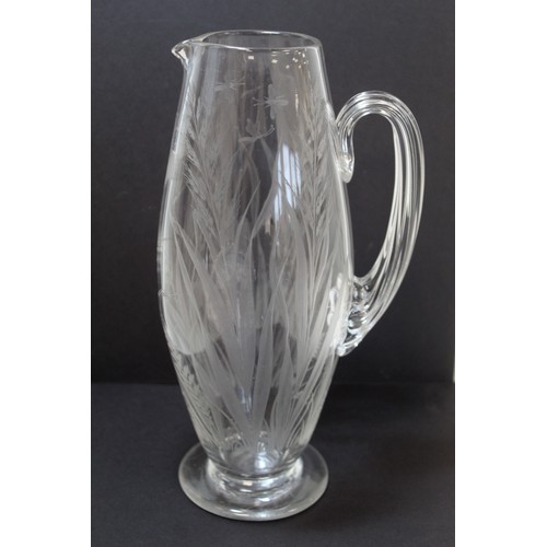 243 - Late 19th/early 20th century water jug of ovoid form with reeded handle and etched decoration of but... 